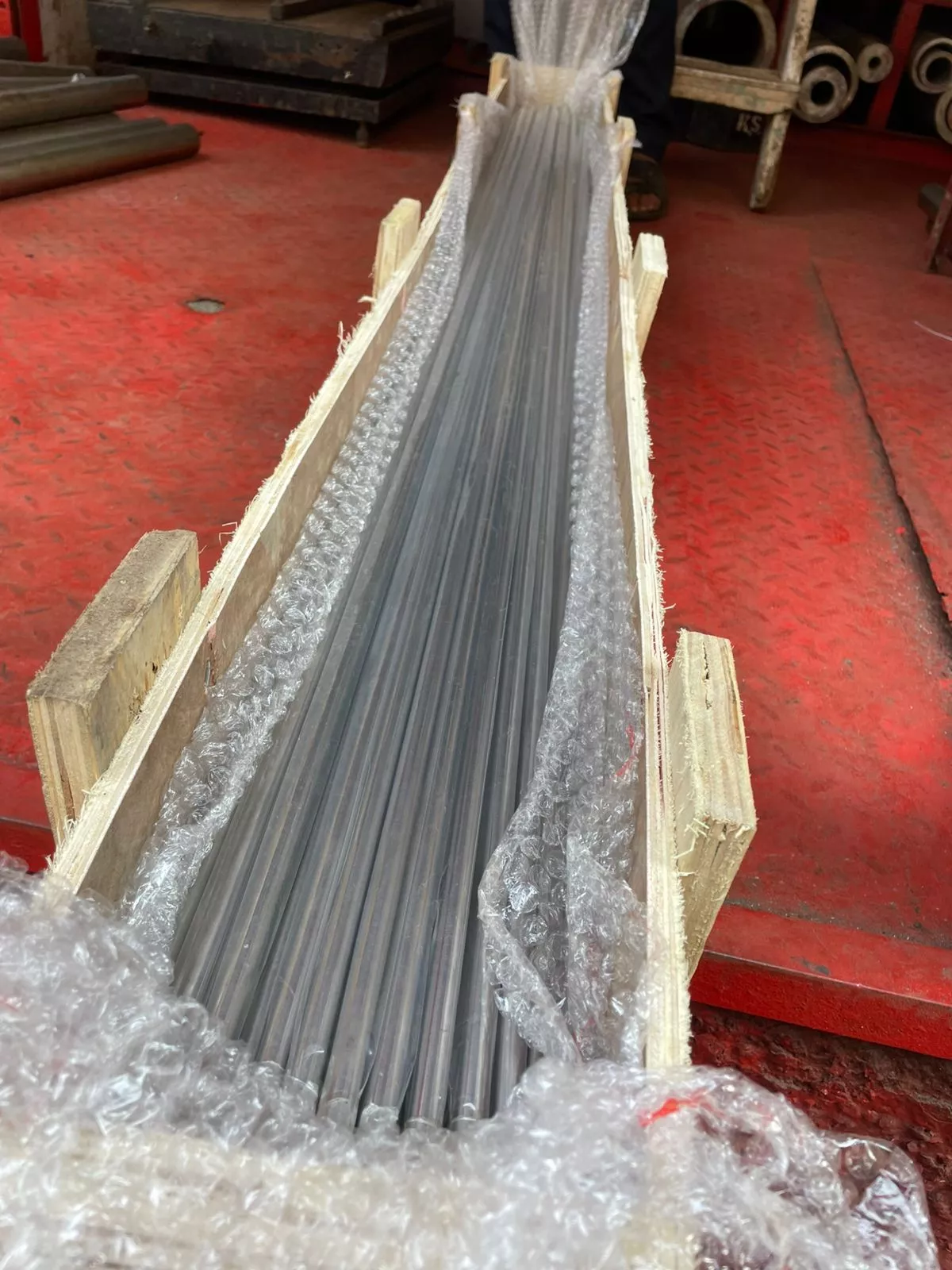 Stainless steel tube checked for straightness on inspection table